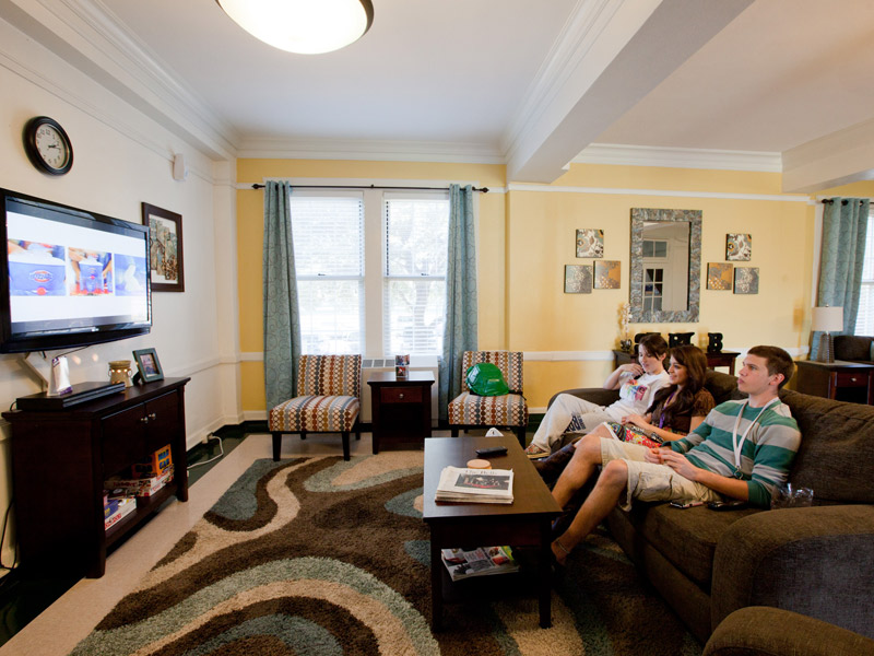 Students relaxing in a residence hall lobby